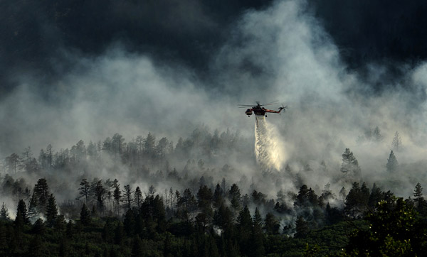 A helicopter drops water on the Waldo Canyon Fire on June 27, 2012