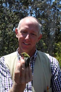Dr. David Flaspohler with a non-native Japanese white-eye.