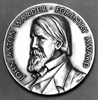 The John Aston Warder award, featuring his likeness. 