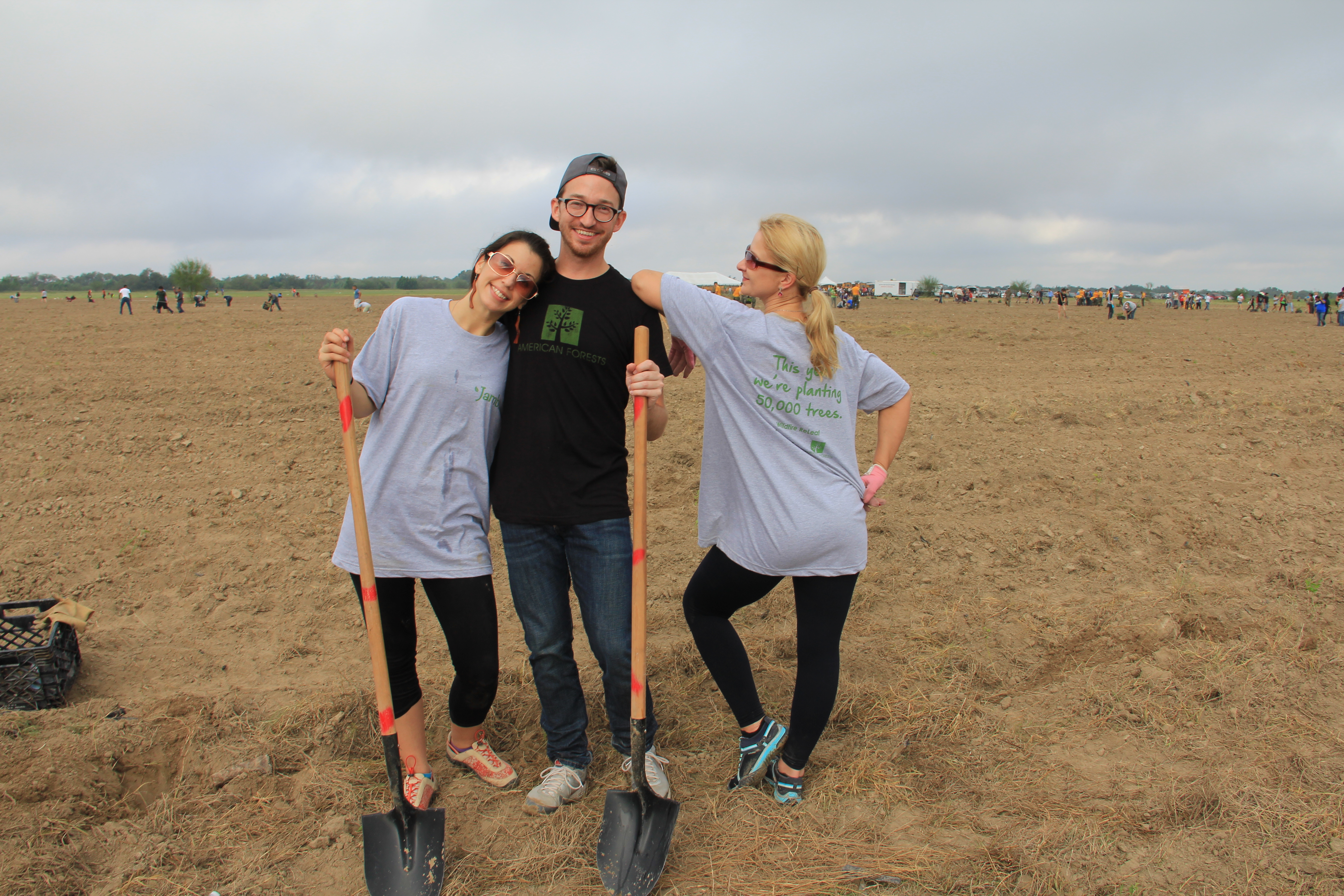 American Forests staff and Volunteers standing in empty field with shovels