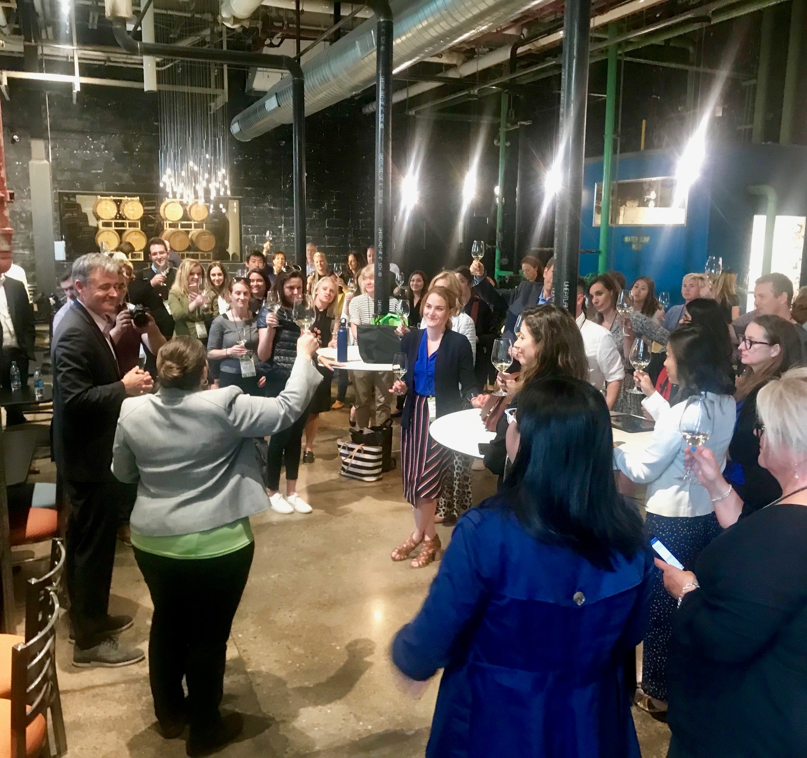 Jennifer Broome, vice president of philanthropy, raises a glass to toast the participants and local hosts while at Detroit Vineyards, the last stop on the Deep Roots Detroit Sustainability Tour.