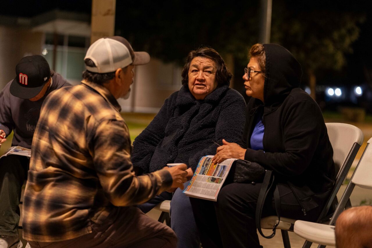 Perea talks through future plans with local residents during an Unlimited Potential community outreach event.
