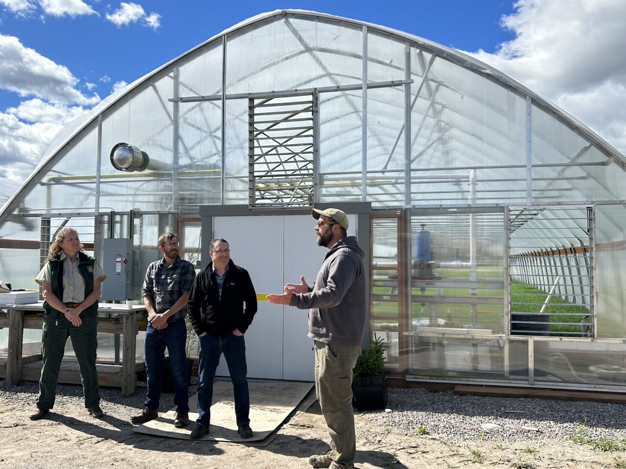 Michael Butts, Montana DNRC nursery manager, tours Matt Arno, Wes Swaffar, Jennifer Hensiek and others around the Anaconda greenhouse during the grand opening of the building.