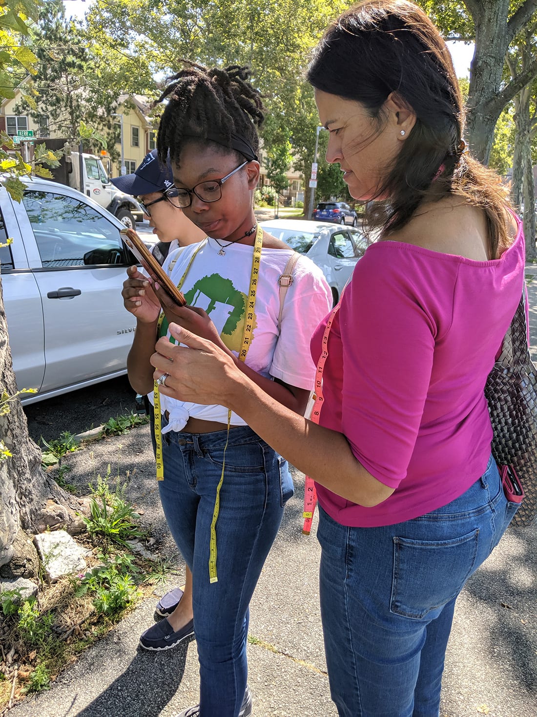 Teen Urban Tree Corps member Maya Hall demonstrates how to input data on a street tree to Boston City Councilor Annissa Essaibi George.