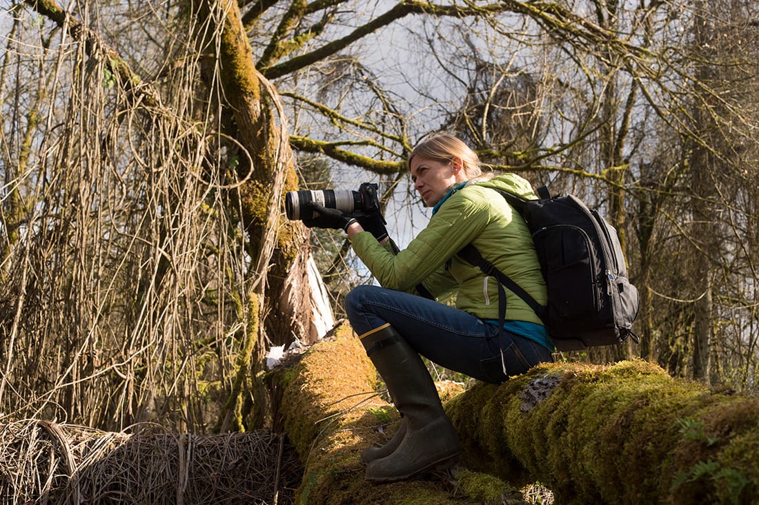 Photographer Jenny Nichols in action capturing the beauty of the forest around her.