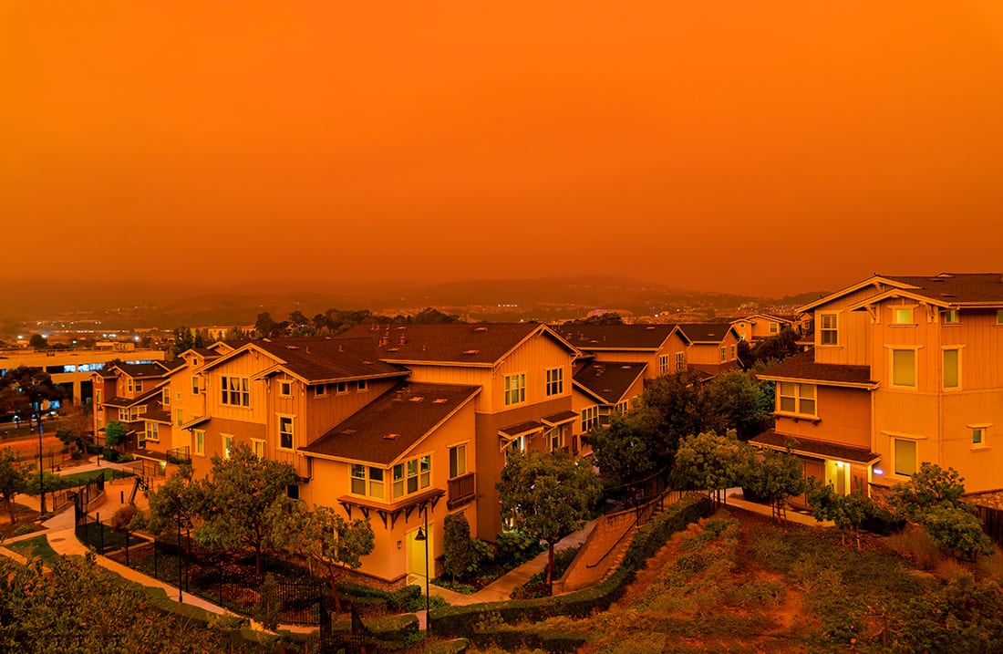 Wildfire smoke exposure is linked to cardiovascular issues and increased susceptibility to the flu and COVID-19. Due to record wildfires in California, this photo shows the resulting thick orange haze above San Francisco with ash and smoke floating over the Bay Area.