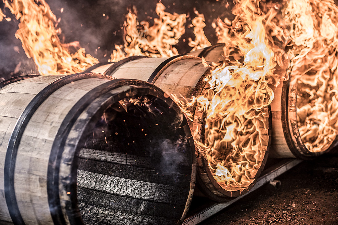 Oak barrels being charred at Kentucky Cooperage in Lebanon, Ky. The charred American oak barrel is a cornerstone of American whiskey, and white oaks specifically are used in the aging of bourbon. Barrel makers char spirit barrels to create flavor, color, aroma, a char layer that acts as a filter, and to break down the wood cell walls so the spirit can extract flavors from the oak.