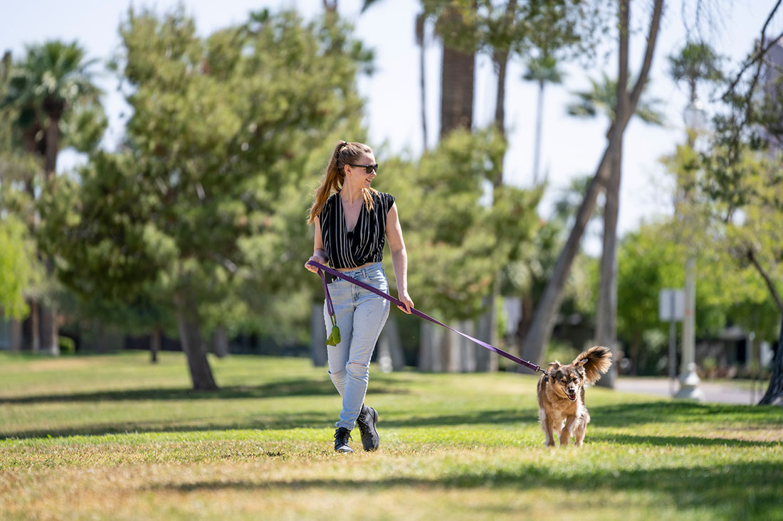 A woman embraces a scenic route where she takes her dog for daily walks through Phoenix’s Encanto Park.