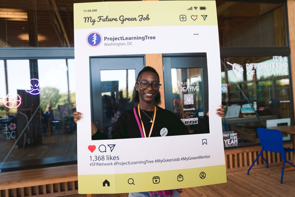 A student pictures herself in a green career as part of Project Learning Tree’s booth that explores representations of Black people in the field. Jada M Imani / American Forests
