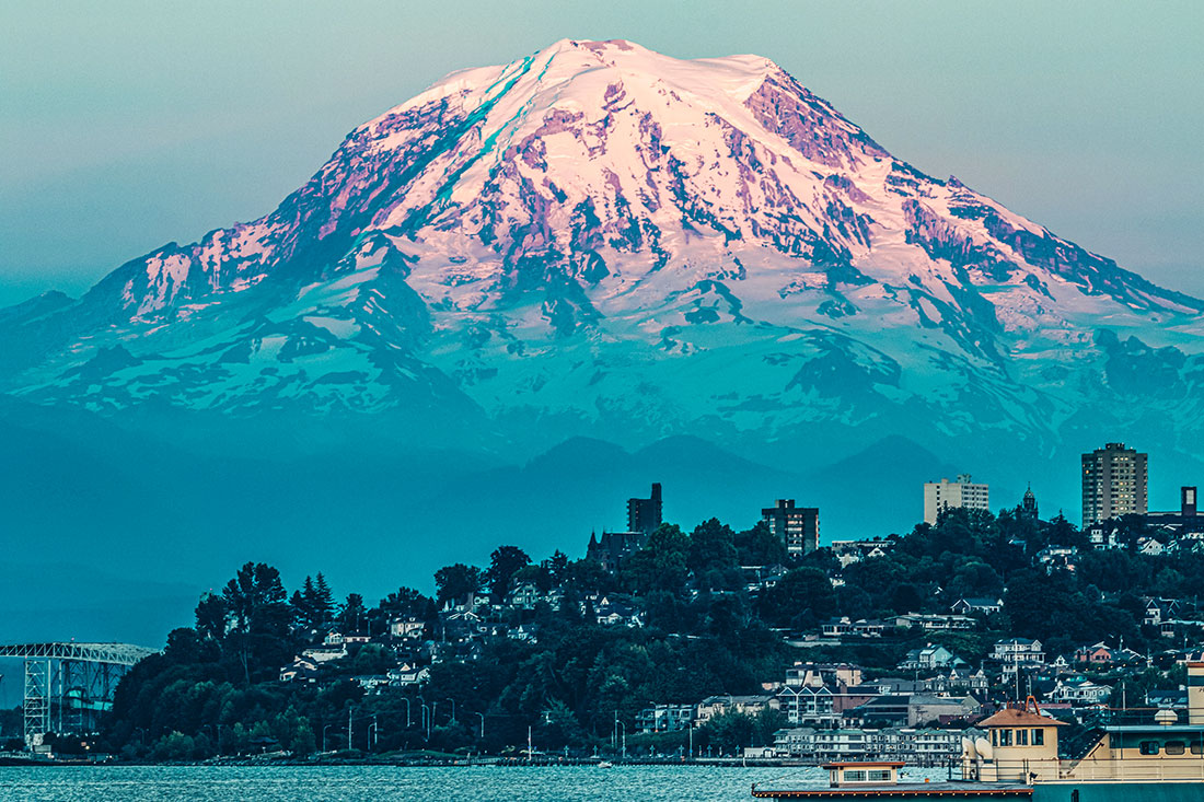 ount Rainier looms over the city of Tacoma, Wash. Its 25 glaciers provide drinking water and support forests, fish, marine life and industries.