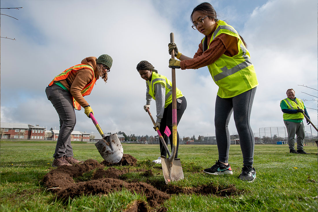 Volunteers and high school biology students plant trees at Mount Tahoma High School, a collaboration between American Forests, The Tacoma Tree Foundation and Weyerhaeuser. The school is located in South Tacoma, in a neighborhood with just 11% tree canopy coverage.