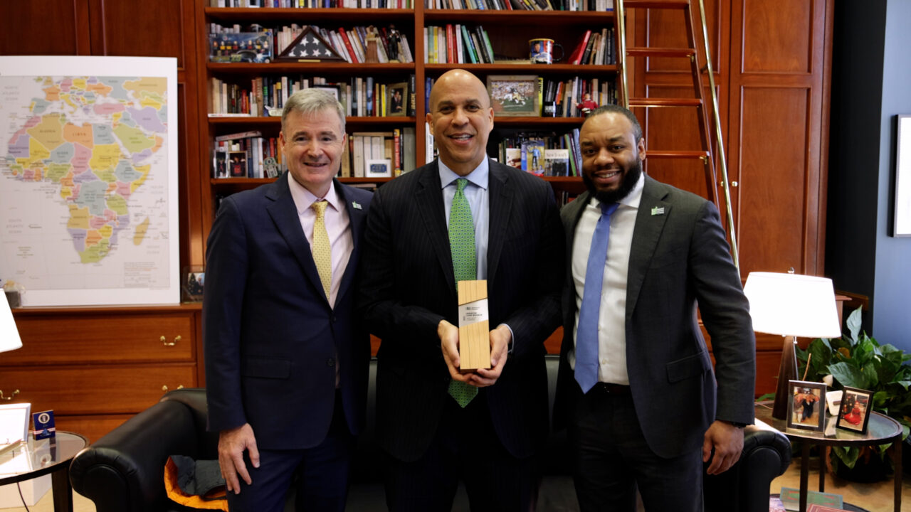 Jad Daley and Joel Pannell give Senator Cory Booker the 2023 Tree Equity Champion Award.