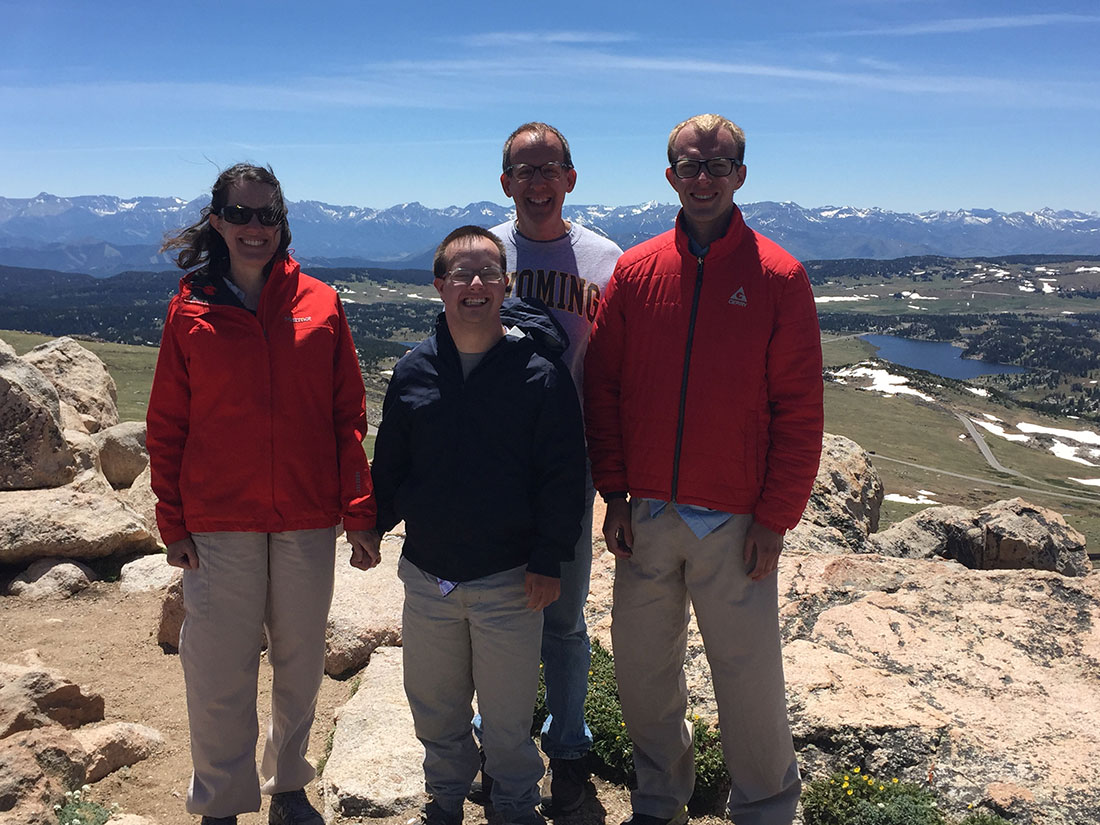 (From L to R) Kathy Evans and her son Benjamin, husband Tim and son Danny pose for a family photo at the top of Beartooth Pass in Wyoming’s Shoshone National Forest during a vacation in June 2021, a trip the family took to visit Kathy’s parents’ graves just months after her mother had passed away.