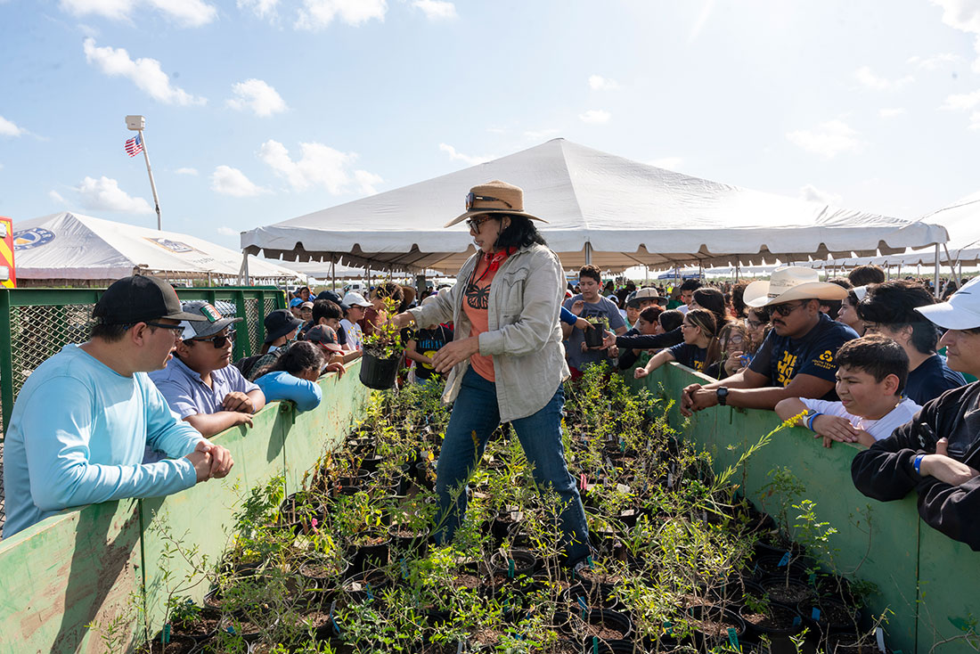Volunteers receive native seedlings to plant at the 2024 Rio Reforestation community planting event in Texas' Rio Grande Valley.