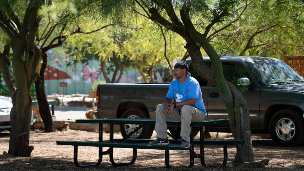 Phoenix man seeking rest under the shade of a tree.