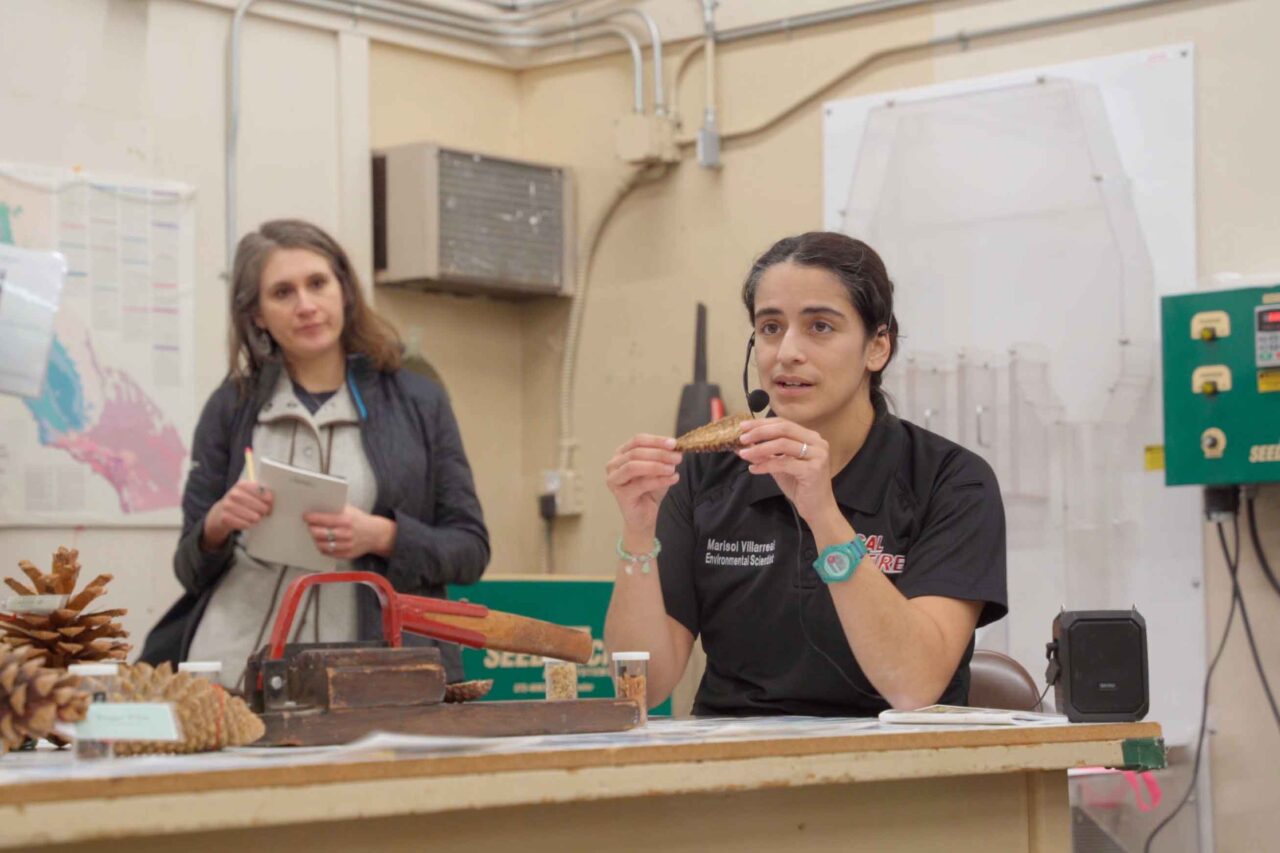 Marisol Villareal, assistant seedbank manager with the CAL FIRE Reforestation Services Program, explains protocols for testing the viability of collected seeds for storage during a tour of the state nursery and seedbank in Davis, Calif., as part of The Understory event.